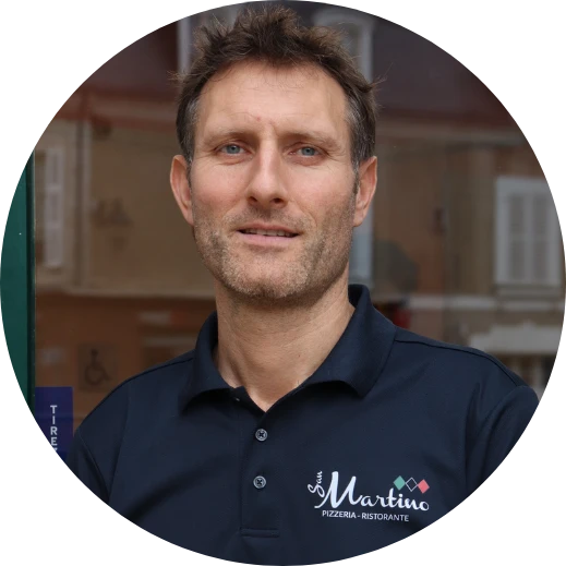 Man in Martino Pizzeria navy polo shirt