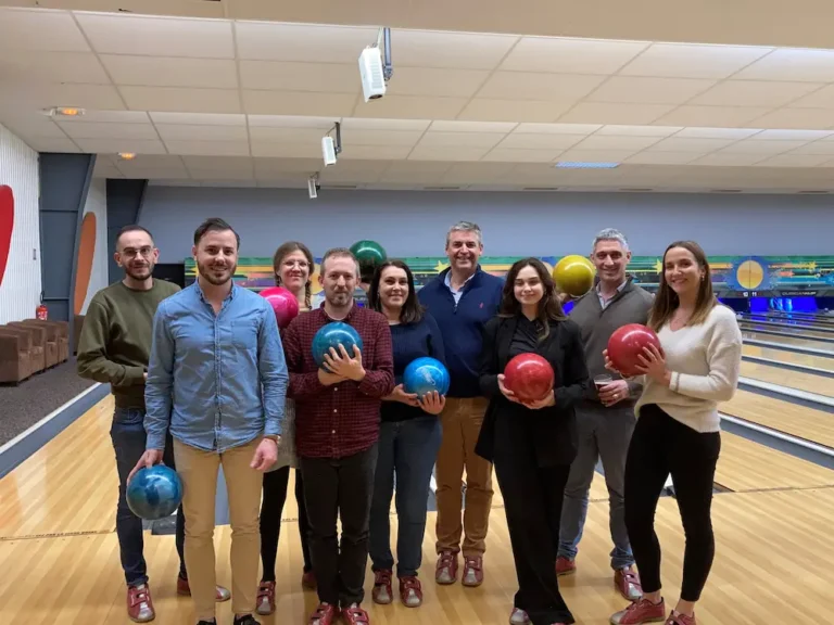 Group holding bowling balls at bowling alley