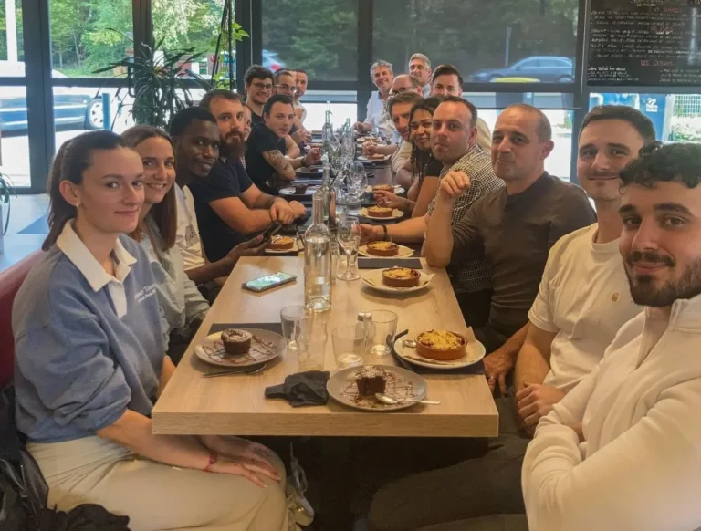 Group dining together at restaurant table with desserts